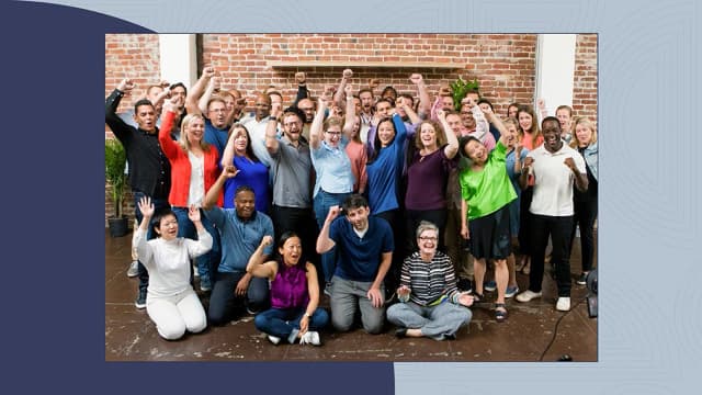 Group of empathetic leaders posing and pumping their fists in the air with excitement